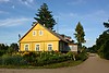 Yellow farm house near Nemunaitis, Lithuania